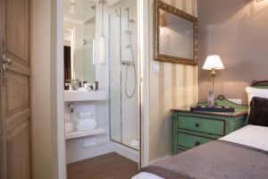 room with open door on the bathroom with shower at hotel des 2 continents Paris 6 - romantic weekend