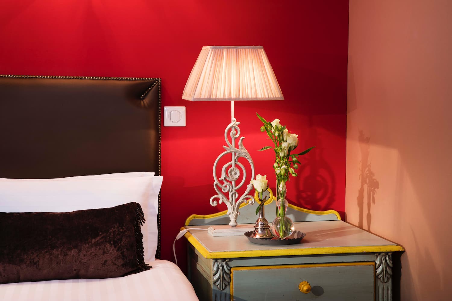 hotel room with bed, pillow, lamp, and green furniture - book a hotel in Paris center
