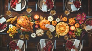 Thanksgiving in Paris. Table with a typical Thanksgiving meal with turkey, pumpkin pie and delicious vegetables of the season.