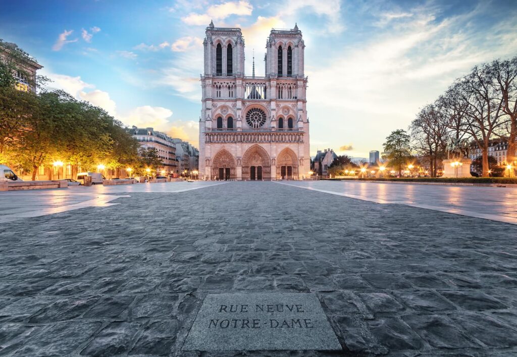 Hotel for Roland Garros Paris: We can see a large cobblestone walkway which leads to the impressive Cathedral of Notre-Dame de Paris. All under a comforting blue sky.
